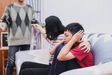 parents fighting child covering ears