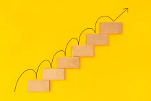 rising-arrow-on-wooden-staircase