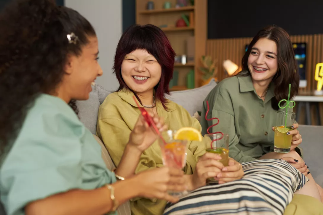 girls-chatting-during-party-in-living-room