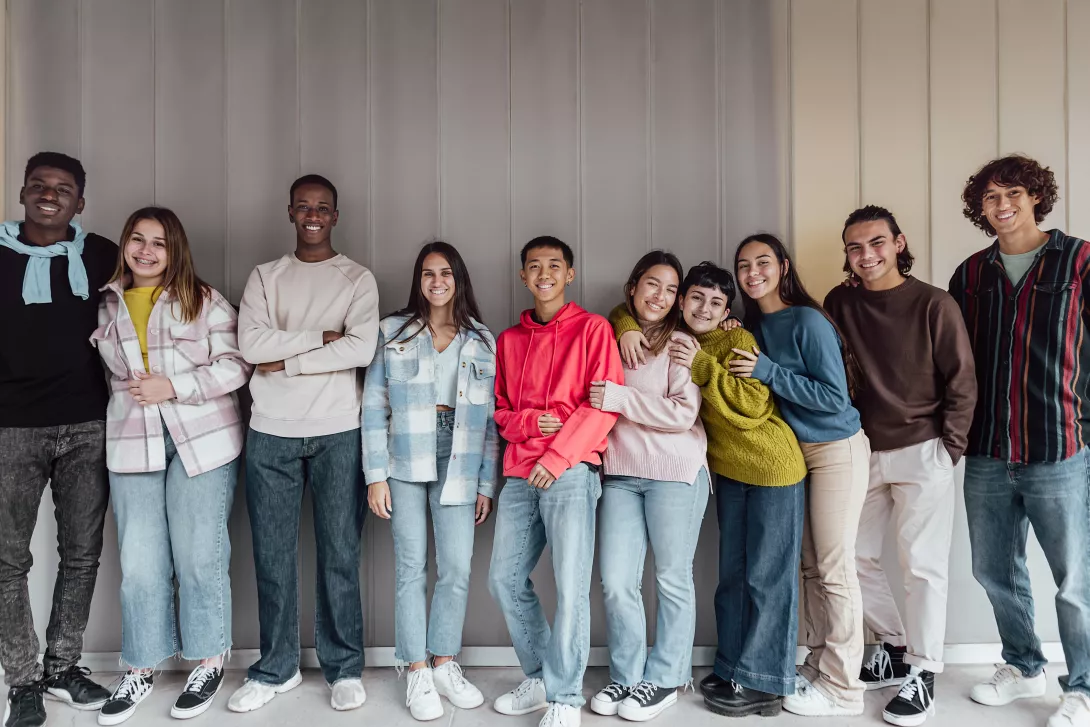 multiracial group of kids a teens smiling to camera