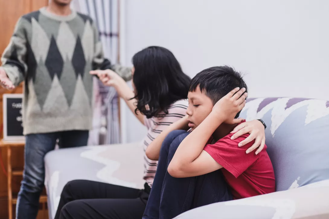 parents fighting child covering ears