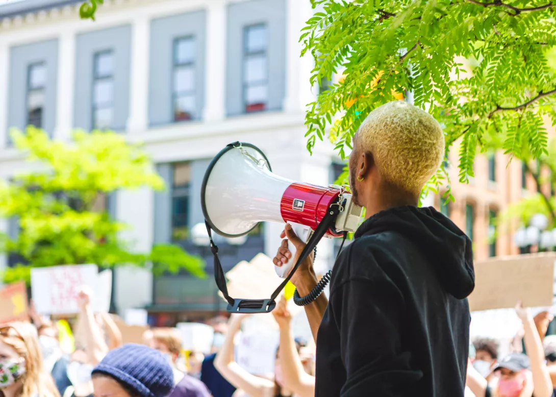 person-of-color-holding-a-megaphone-at-a-peaceful