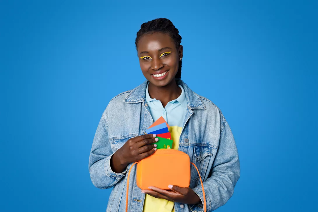 positive-stylish-young-black-woman-holding-purse