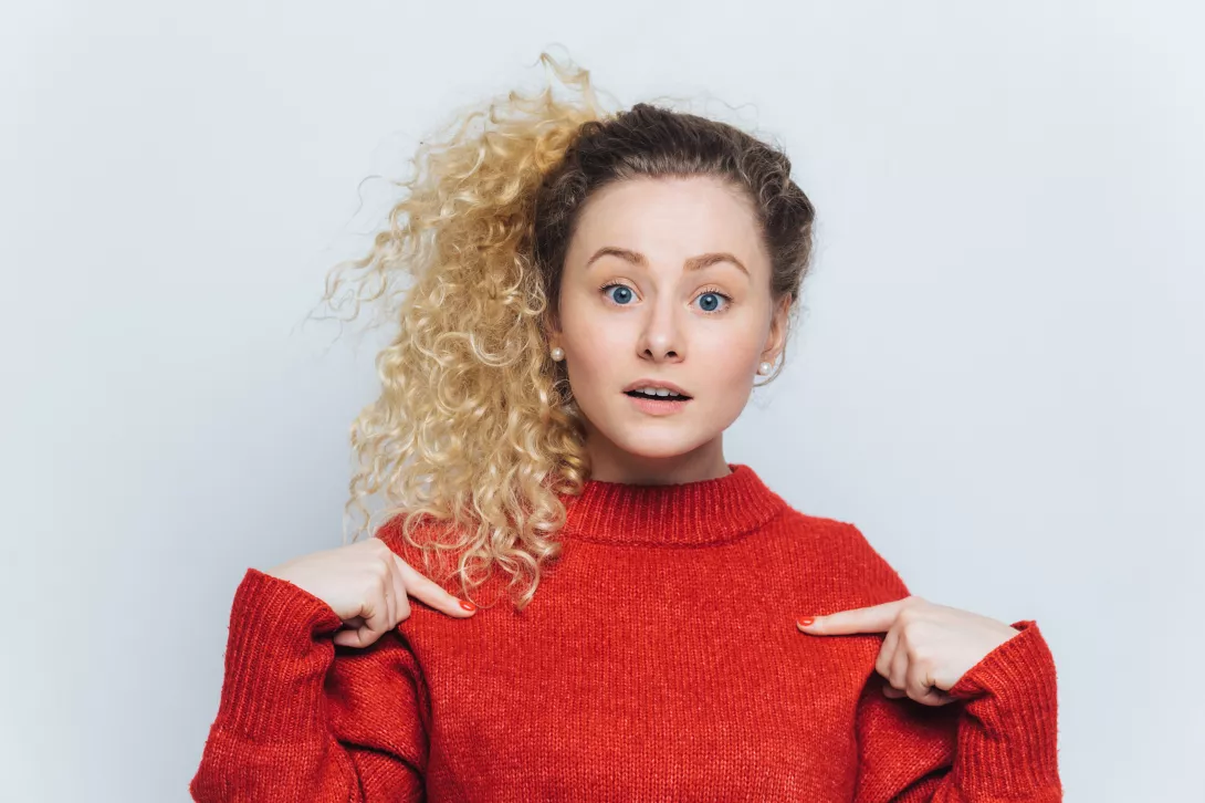 pretty-young-female-in-bewilderment-wears-red-warm