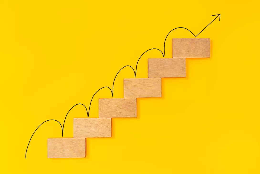 rising-arrow-on-wooden-staircase